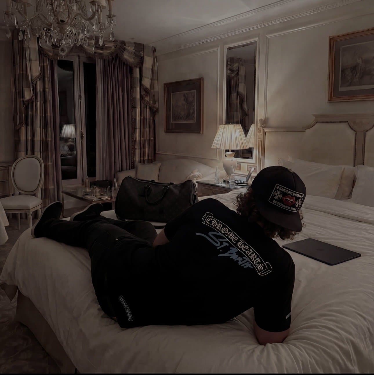 Luka working on his laptop in a hotel suite